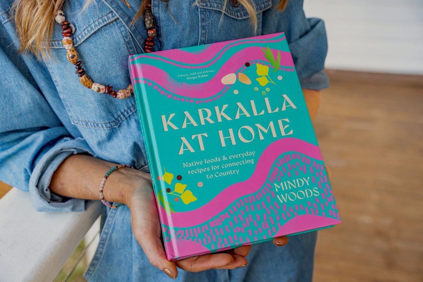 Karkalla at Home cookbook held in two hands