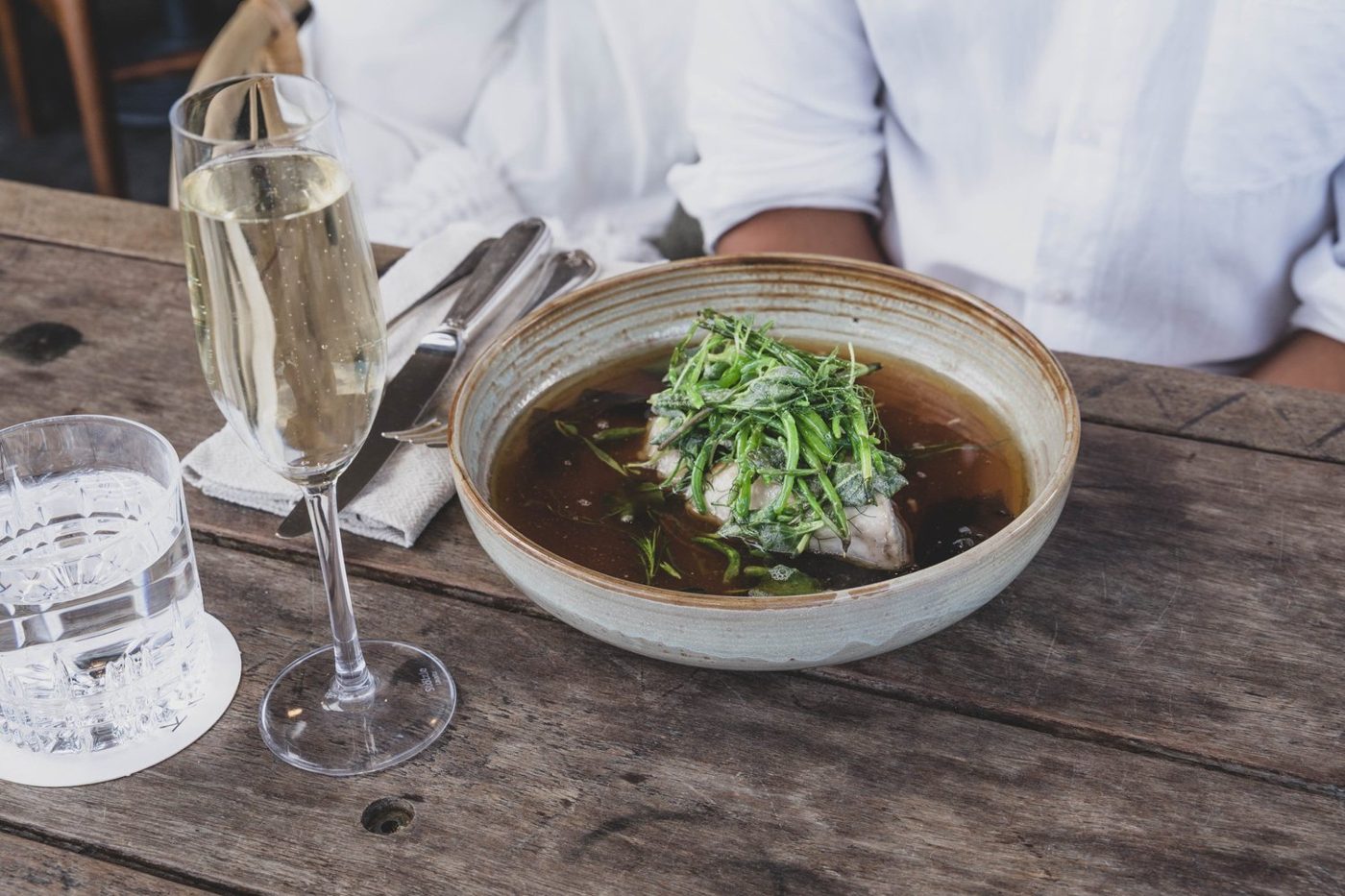 Steamed fish in kombu broth with blistered succulents