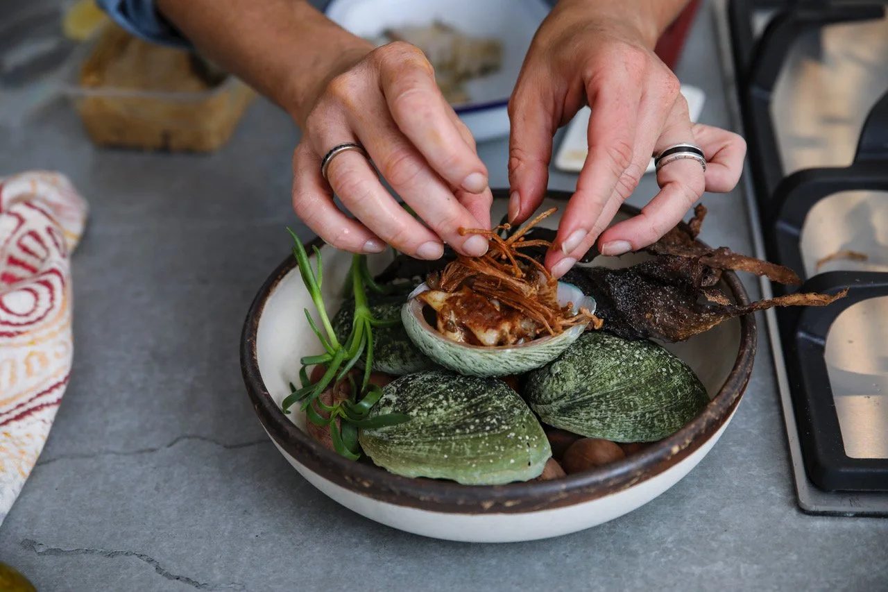 Mindy plating native ingredients on shells