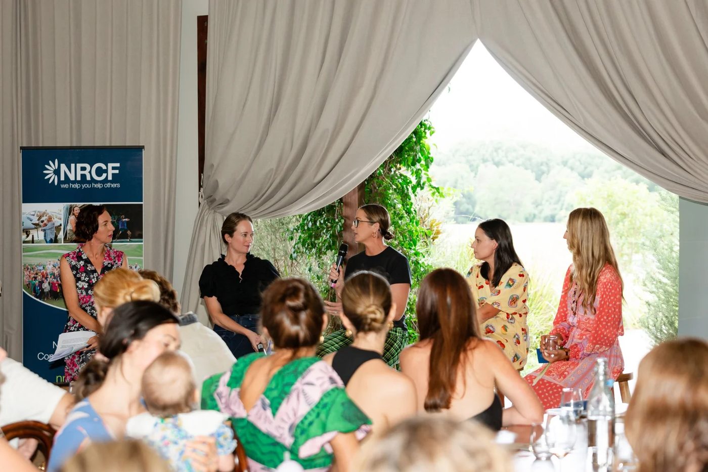 Panel discussion in front of a seated audience